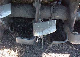 The blades on the rotary hoe churn the soil into very fine pieces.
